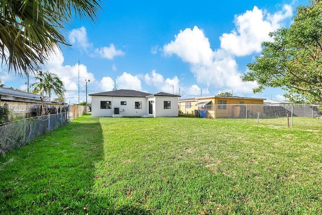 back of house featuring a yard