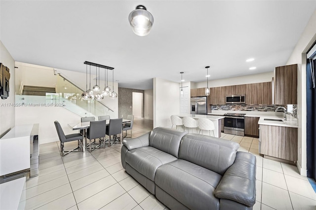 living room with sink and light tile patterned floors