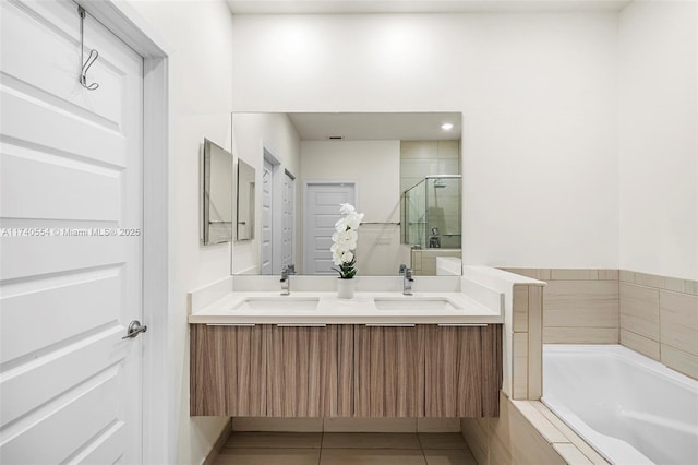 bathroom featuring tile patterned flooring, vanity, and separate shower and tub