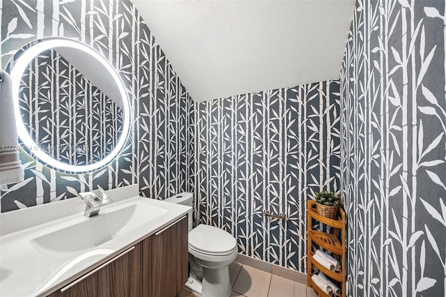 bathroom with vanity, tile patterned flooring, a textured ceiling, and toilet