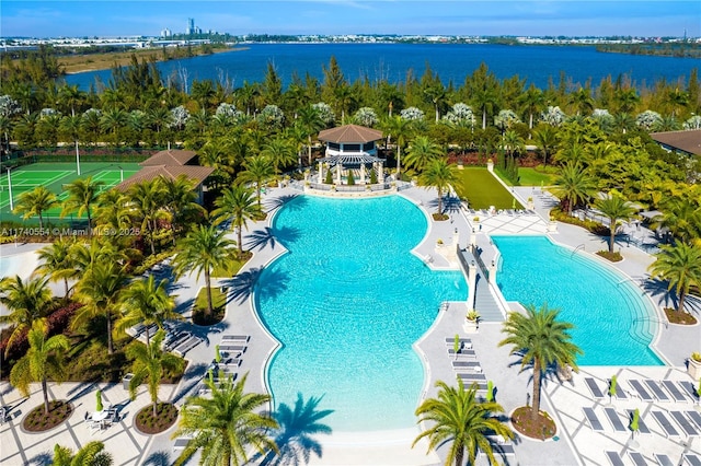 view of pool with a water view and a patio area