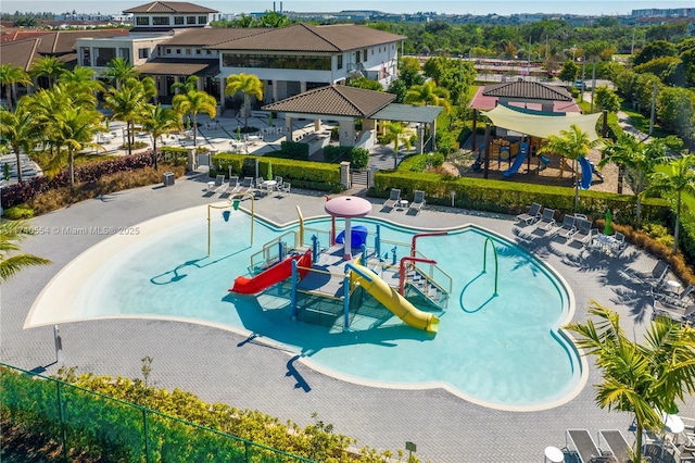 view of pool featuring a playground and a patio area