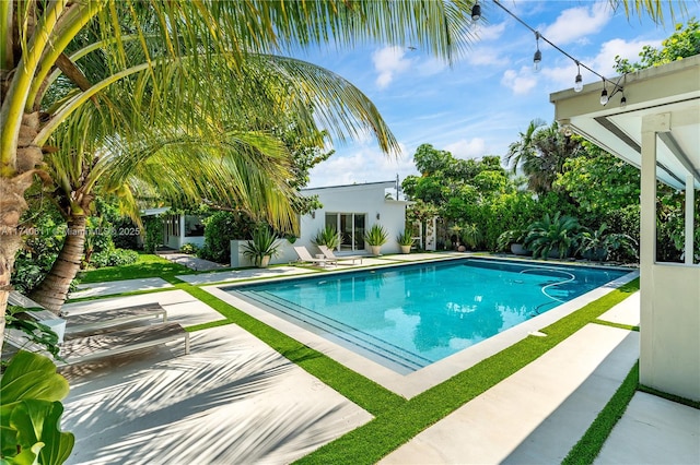 view of swimming pool featuring a fenced in pool and a patio area