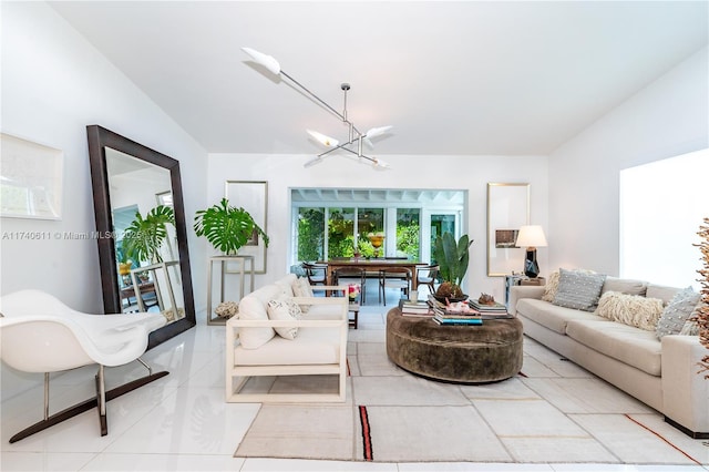 living room featuring light tile patterned flooring and a notable chandelier