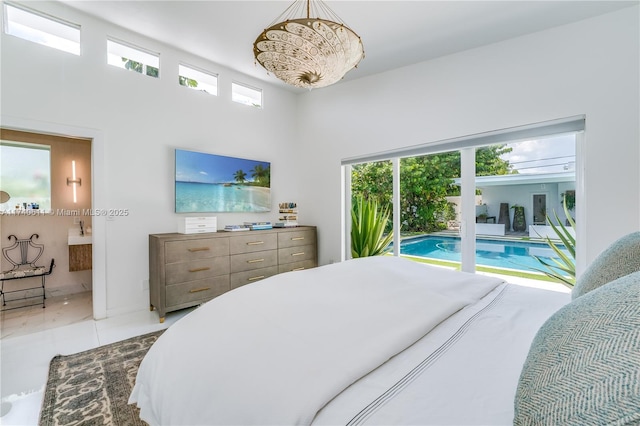 bedroom featuring tile patterned floors, multiple windows, and ensuite bathroom