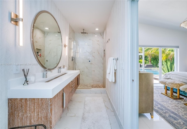 bathroom with recessed lighting, a marble finish shower, marble finish floor, and vanity