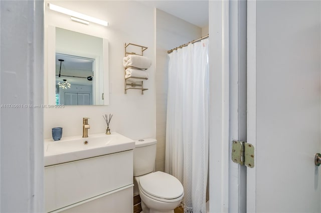 bathroom with toilet and vanity