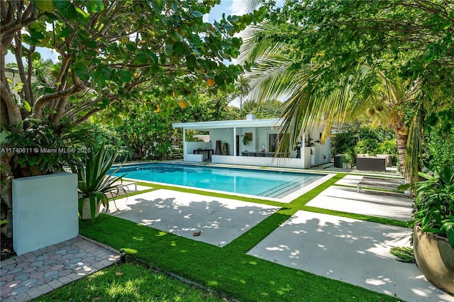 pool with a patio and an outdoor hangout area
