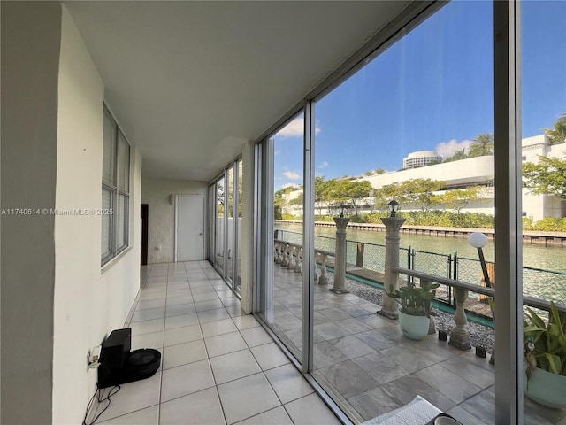 unfurnished sunroom with a water view