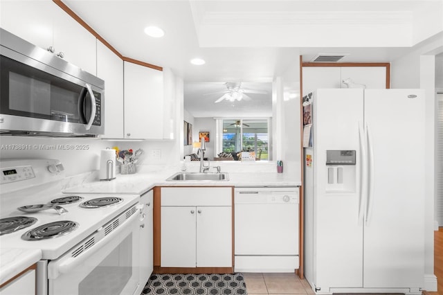 kitchen with white cabinetry, sink, crown molding, and white appliances