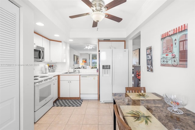 kitchen with white cabinetry, sink, light tile patterned floors, crown molding, and white appliances