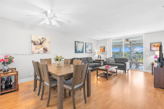 dining room with ceiling fan, light hardwood / wood-style floors, and a textured ceiling