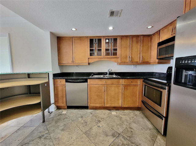 kitchen featuring sink, a textured ceiling, and appliances with stainless steel finishes