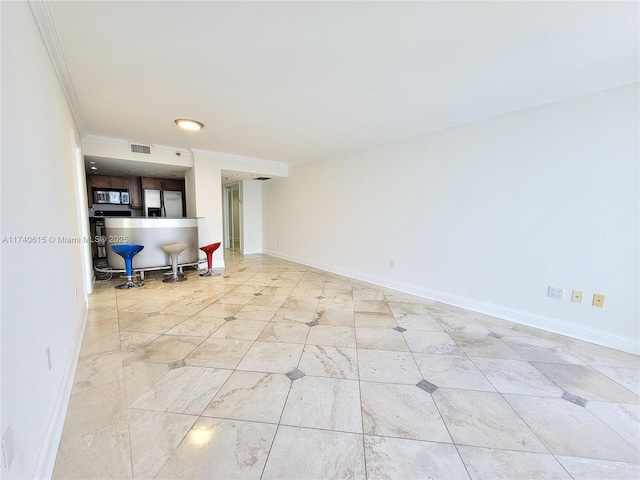 unfurnished room with crown molding