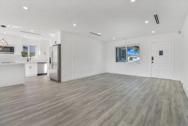 unfurnished living room featuring light hardwood / wood-style floors