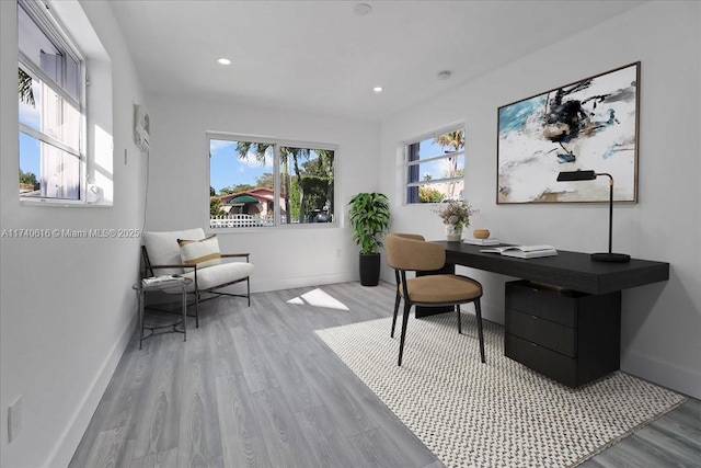 home office featuring a wealth of natural light and light hardwood / wood-style flooring