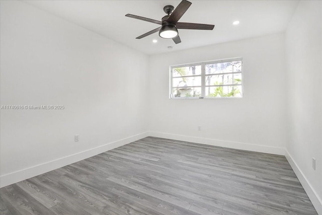 spare room with hardwood / wood-style floors and ceiling fan