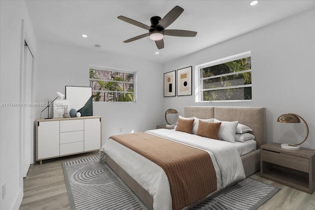 bedroom with light hardwood / wood-style floors and ceiling fan