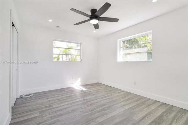 unfurnished room with ceiling fan and light hardwood / wood-style flooring