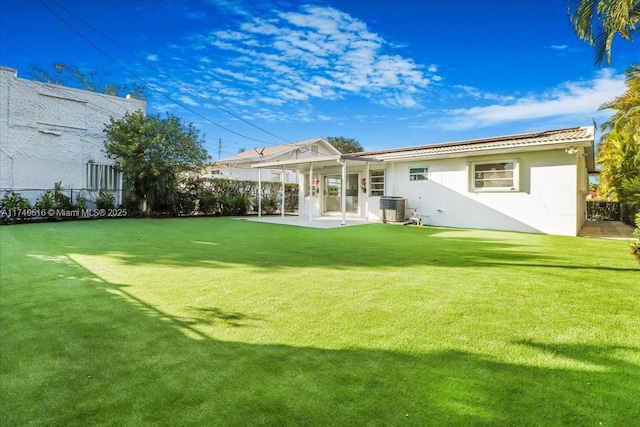 back of house featuring a lawn, a patio area, and central air condition unit