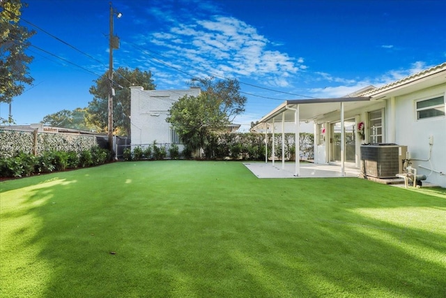 view of yard with central AC and a patio area