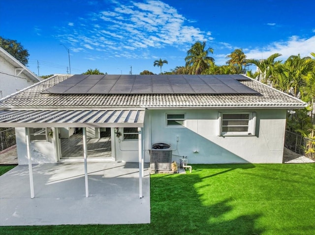 back of house with a lawn, a patio, and central air condition unit