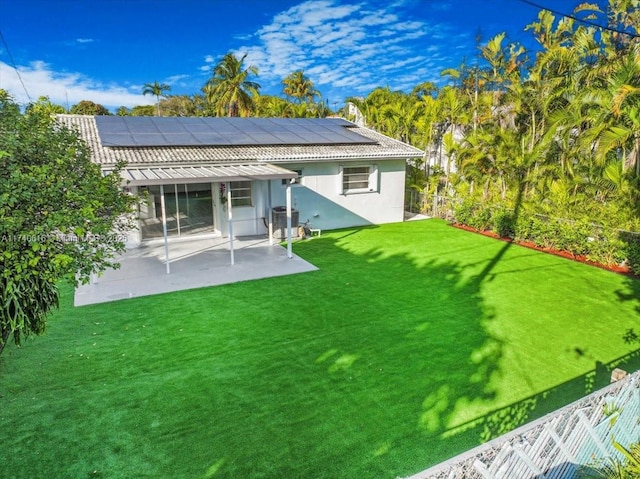 rear view of house featuring cooling unit, a yard, and a patio