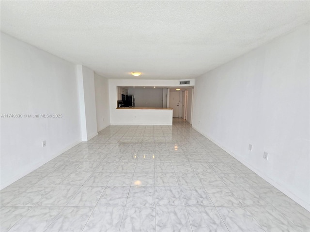 unfurnished room featuring a textured ceiling