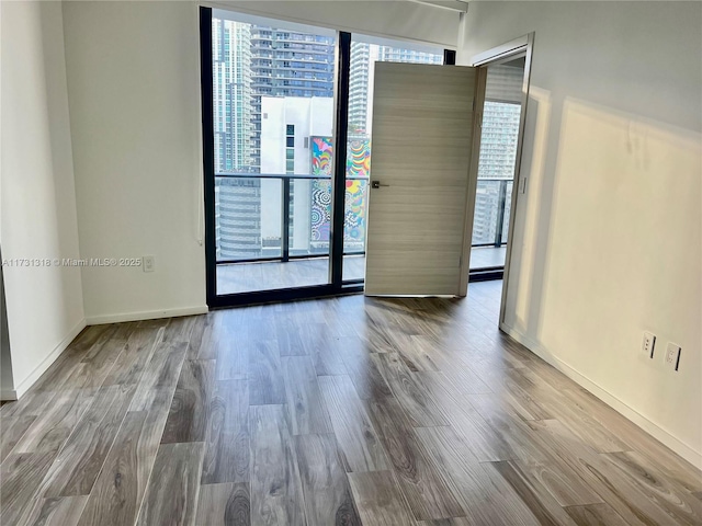 unfurnished room featuring hardwood / wood-style flooring