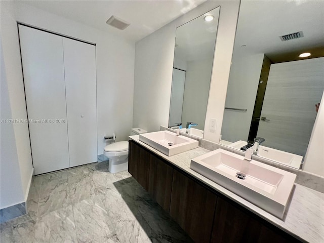 bathroom with vanity and toilet