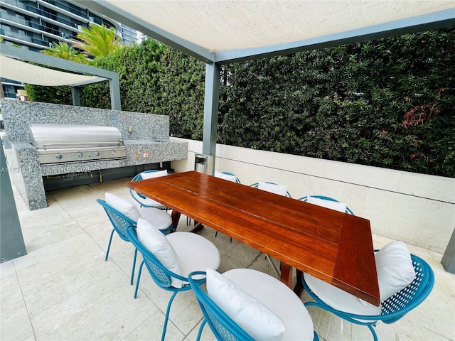 view of patio / terrace featuring a grill and exterior kitchen