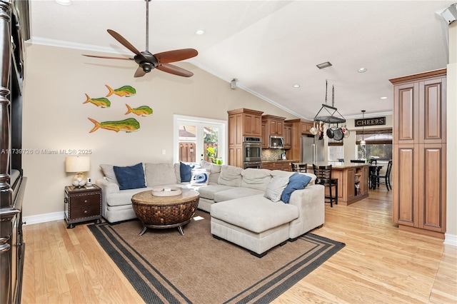 living room with crown molding, ceiling fan, vaulted ceiling, and light hardwood / wood-style flooring