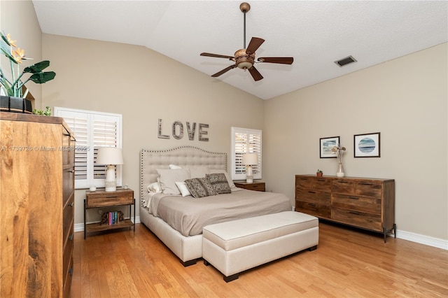 bedroom featuring light hardwood / wood-style flooring, ceiling fan, and vaulted ceiling