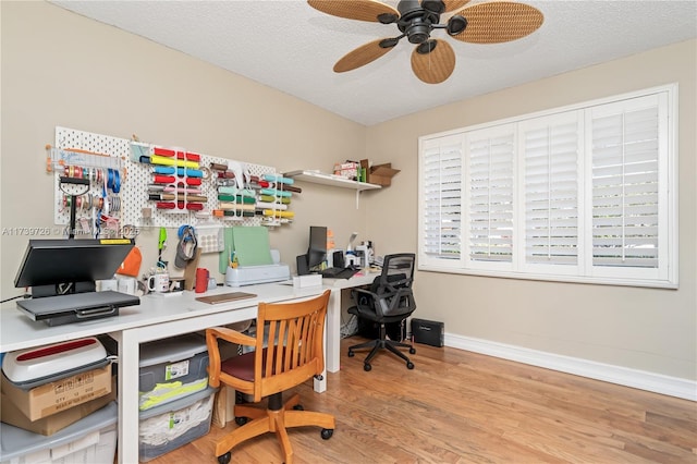 office area with ceiling fan, light hardwood / wood-style floors, and a textured ceiling