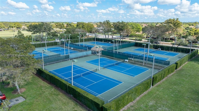 view of sport court featuring a yard