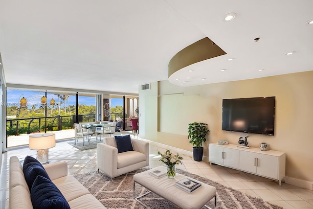 living room with light tile patterned floors, visible vents, recessed lighting, and baseboards