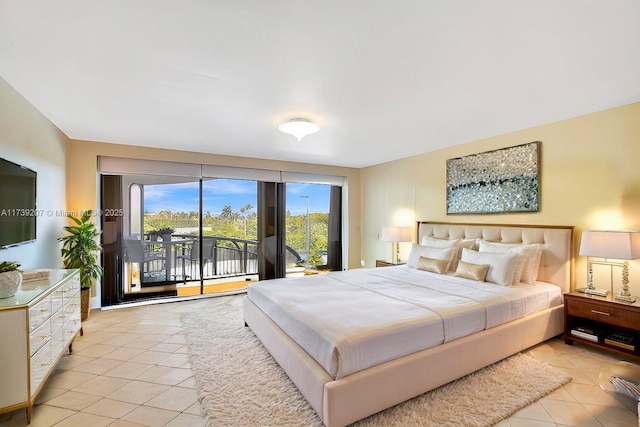 bedroom with access to outside and light tile patterned floors