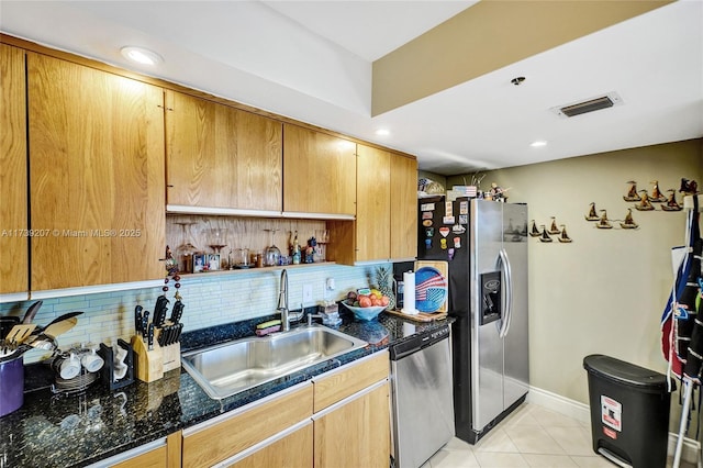 kitchen with visible vents, light tile patterned flooring, a sink, decorative backsplash, and appliances with stainless steel finishes