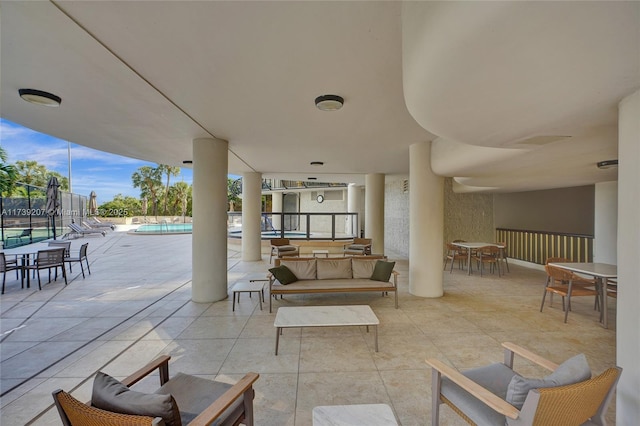 view of patio / terrace with an outdoor hangout area, fence, and a community pool