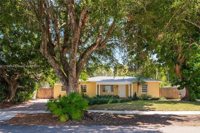 ranch-style home with a front lawn