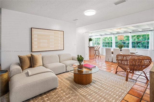 living room featuring tile patterned floors and a textured ceiling