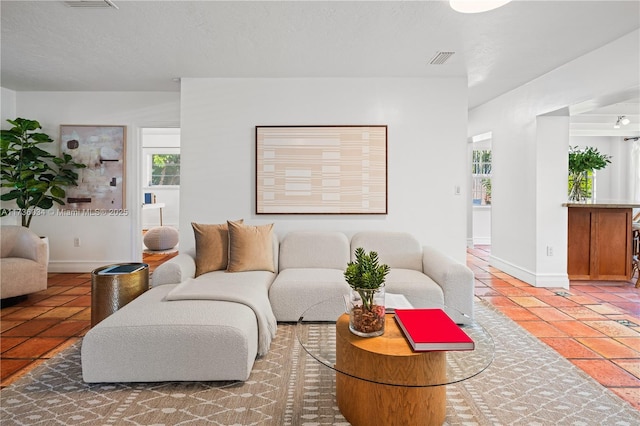 living room featuring tile patterned floors and a textured ceiling