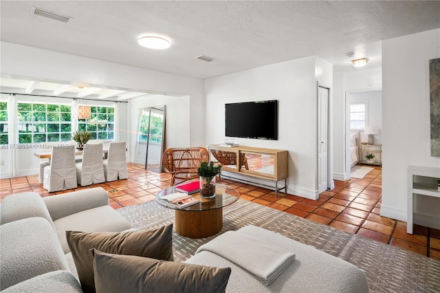 tiled living room featuring a textured ceiling