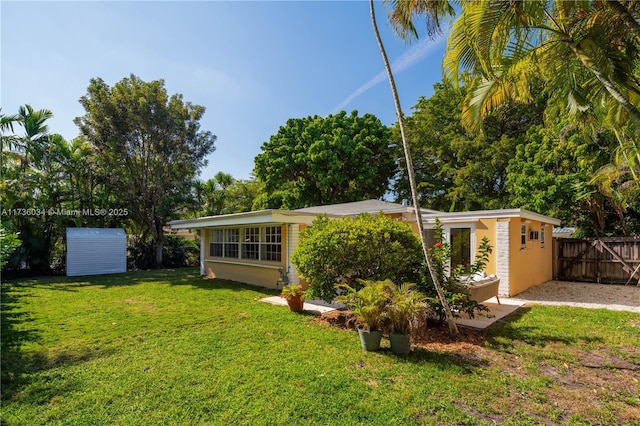 rear view of house with a yard