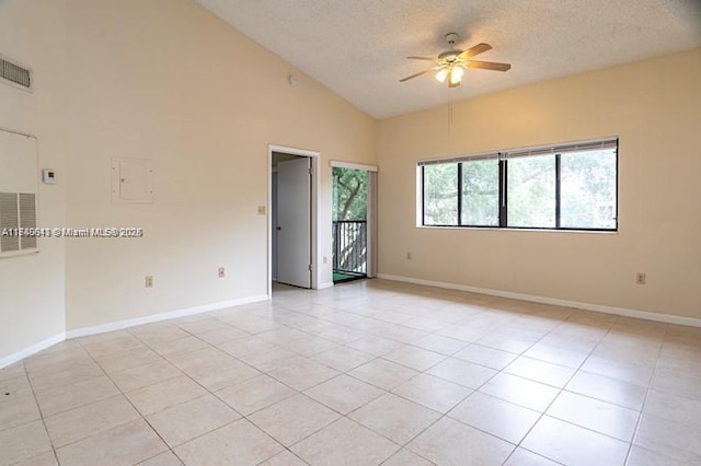 tiled spare room with ceiling fan, high vaulted ceiling, and a textured ceiling