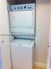 clothes washing area with stacked washer / drying machine