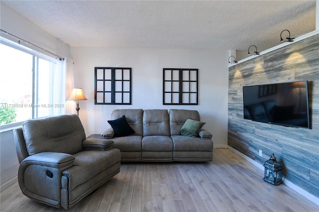 living room featuring wood-type flooring and a textured ceiling