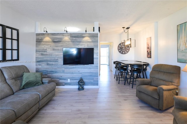 living room featuring light hardwood / wood-style flooring and a textured ceiling