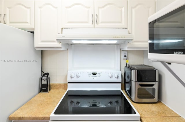 kitchen featuring white cabinetry, backsplash, and white electric stove