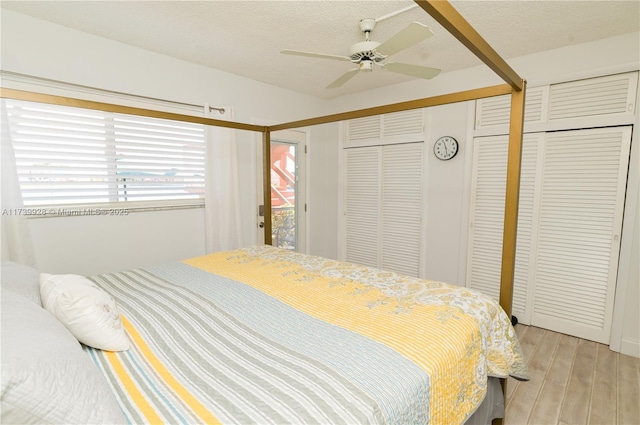 bedroom with ceiling fan, a textured ceiling, and light wood-type flooring